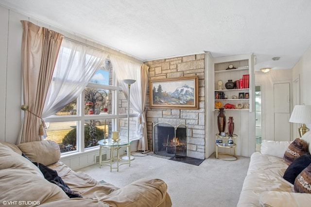 living area featuring carpet, a healthy amount of sunlight, and a textured ceiling