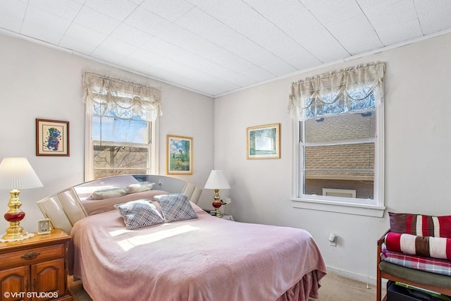 carpeted bedroom with baseboards