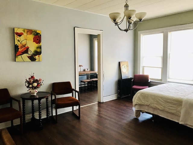 bedroom featuring dark wood-type flooring, radiator heating unit, and a notable chandelier