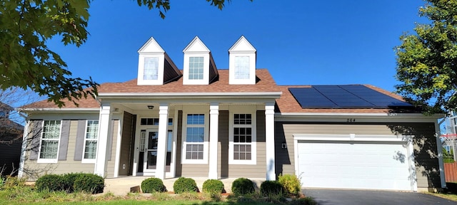 view of front of property featuring a garage and solar panels