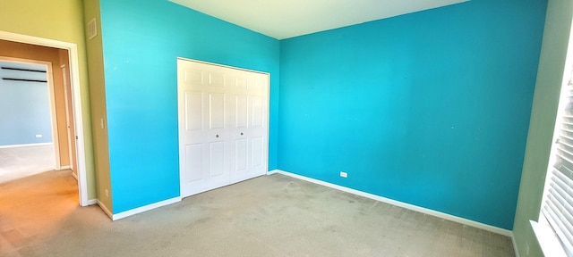 unfurnished bedroom with carpet and a closet