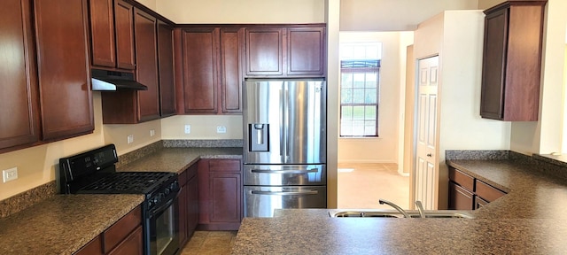 kitchen featuring black gas range oven, sink, and stainless steel fridge with ice dispenser