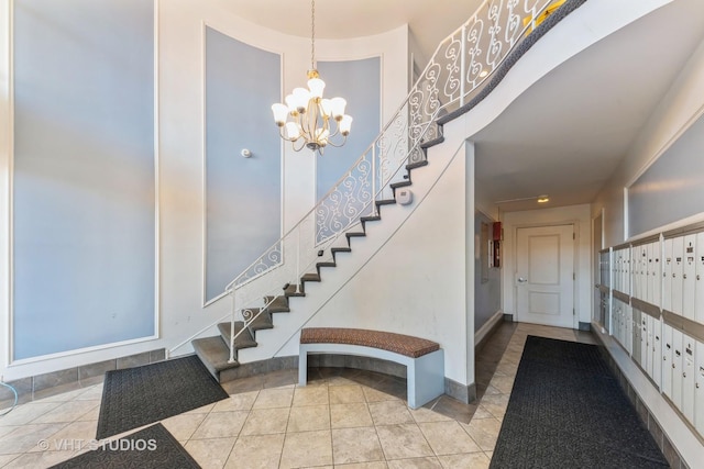 entrance foyer featuring baseboards, mail area, stairway, and tile patterned floors