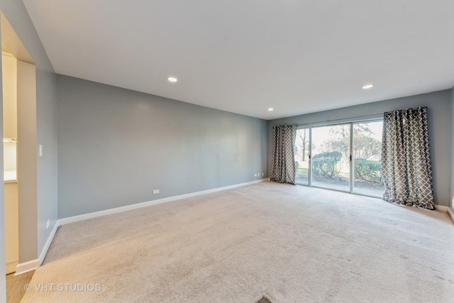 unfurnished room with recessed lighting, light carpet, and baseboards