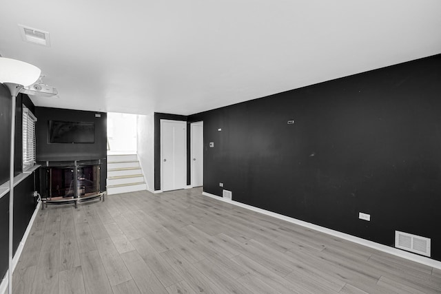 unfurnished living room featuring light hardwood / wood-style flooring