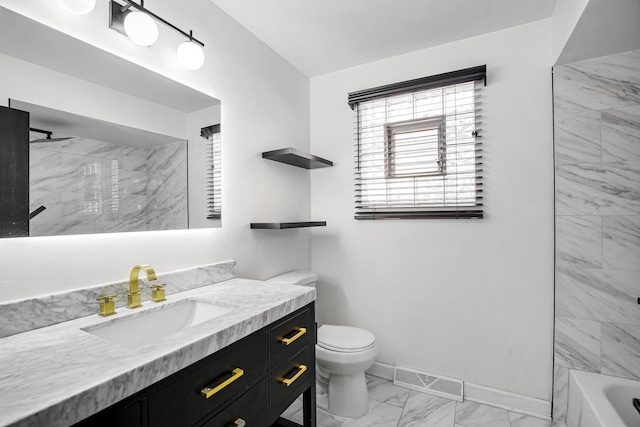 full bathroom featuring tiled shower / bath combo, vanity, and toilet