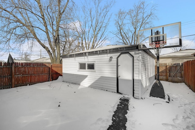 snow covered property with an outdoor structure