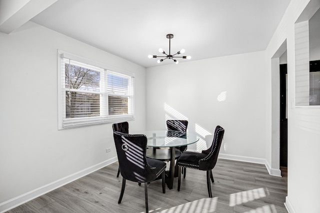 dining room featuring hardwood / wood-style floors and an inviting chandelier