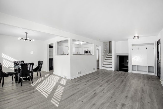 living room with light hardwood / wood-style flooring and a chandelier