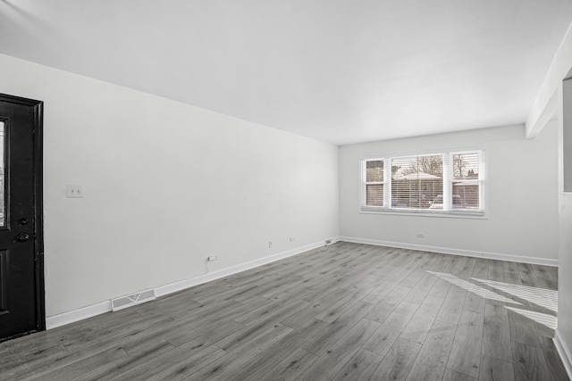 empty room featuring hardwood / wood-style flooring