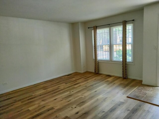 spare room featuring light hardwood / wood-style flooring