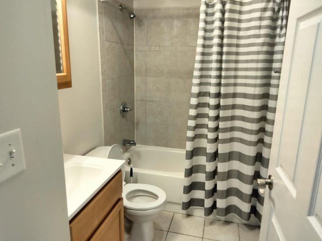 full bathroom featuring toilet, tile patterned flooring, vanity, and shower / tub combo