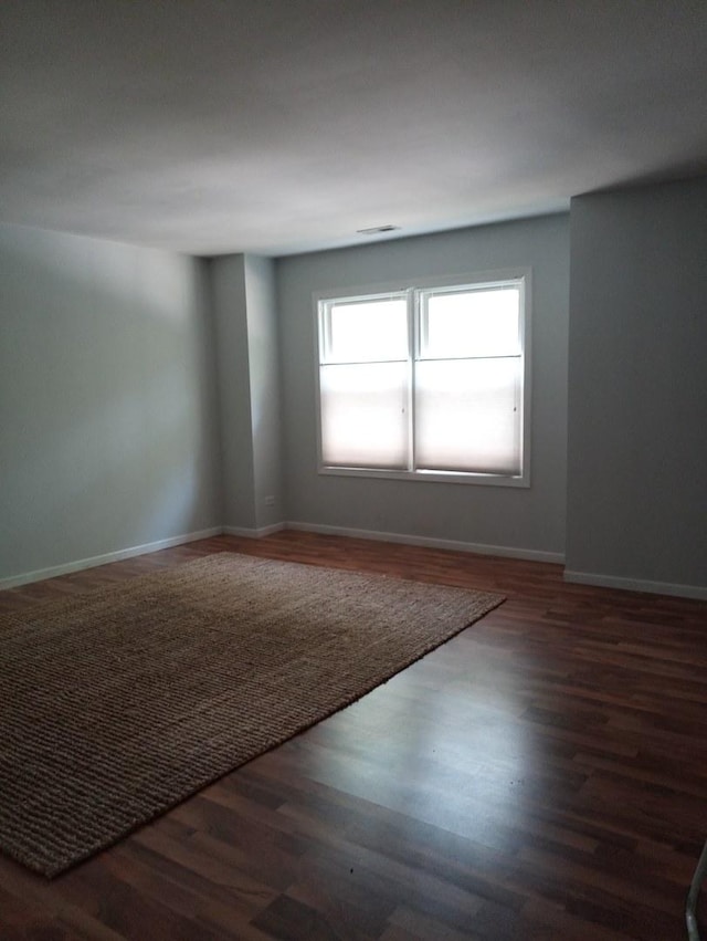 spare room featuring dark hardwood / wood-style floors