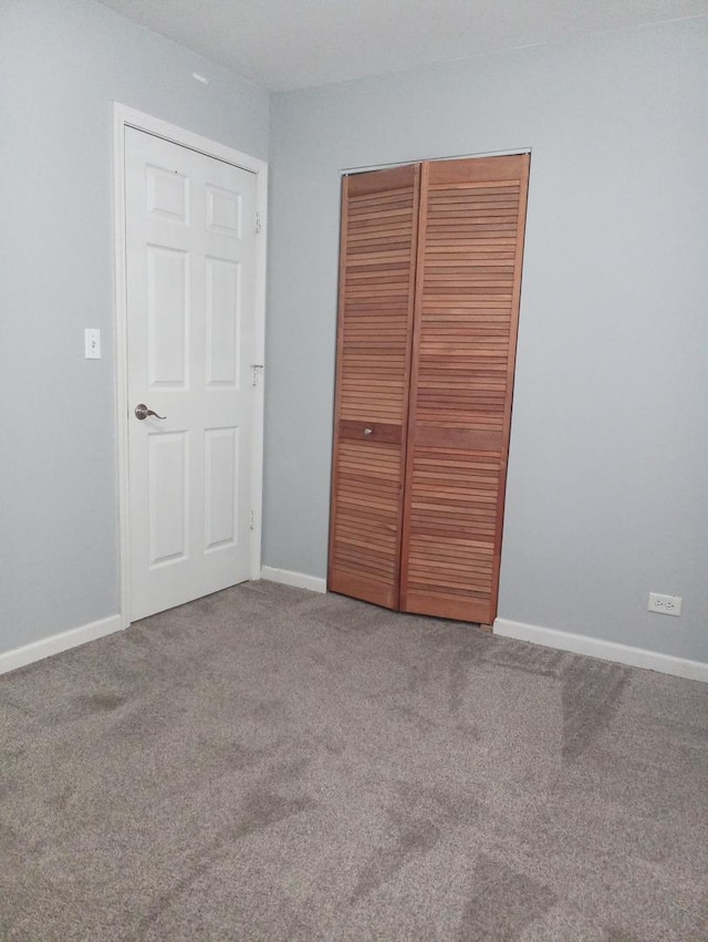 unfurnished bedroom with carpet floors and a closet