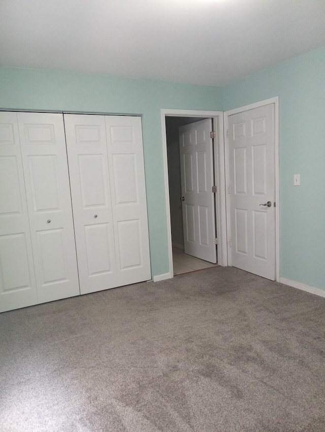 unfurnished bedroom with carpet and a closet