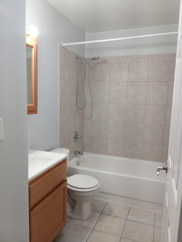 full bathroom featuring tile patterned floors, toilet, vanity, and tiled shower / bath