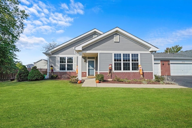 view of front of property featuring a front yard and a garage