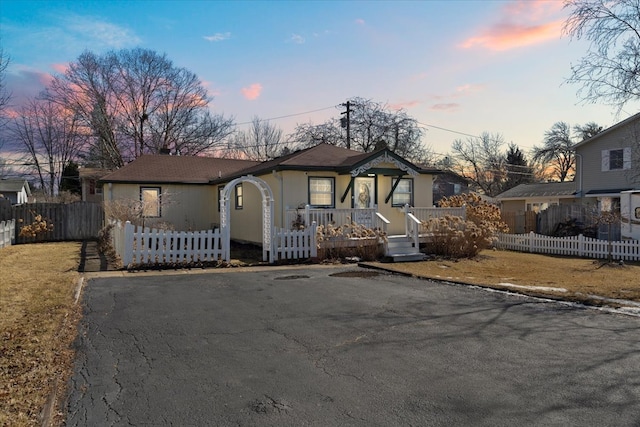 view of front of property with a fenced front yard and aphalt driveway