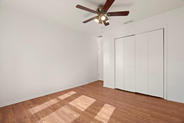 unfurnished bedroom featuring light wood-style flooring, visible vents, and baseboards