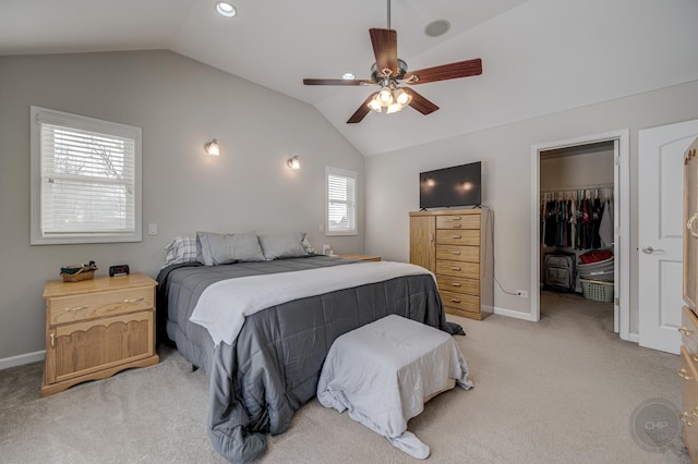 carpeted bedroom with a spacious closet, lofted ceiling, ceiling fan, and a closet