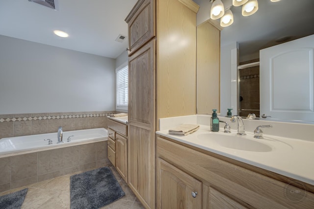 bathroom with vanity, tile patterned flooring, and shower with separate bathtub