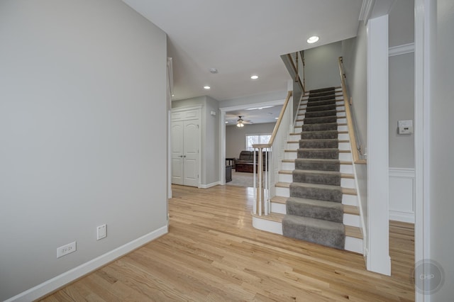 stairs with ceiling fan and wood-type flooring