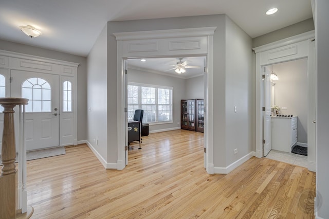 entrance foyer with light hardwood / wood-style floors, crown molding, and ceiling fan