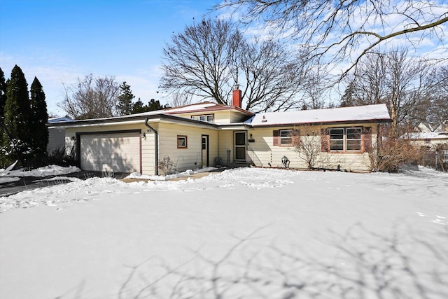 view of front of house featuring an attached garage and a chimney