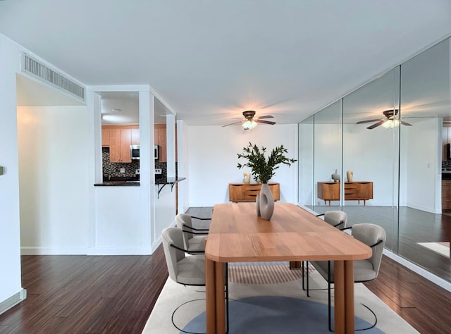 dining room with dark wood-type flooring and ceiling fan