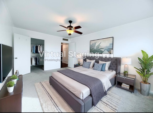 bedroom featuring a closet, ceiling fan, carpet flooring, and a spacious closet