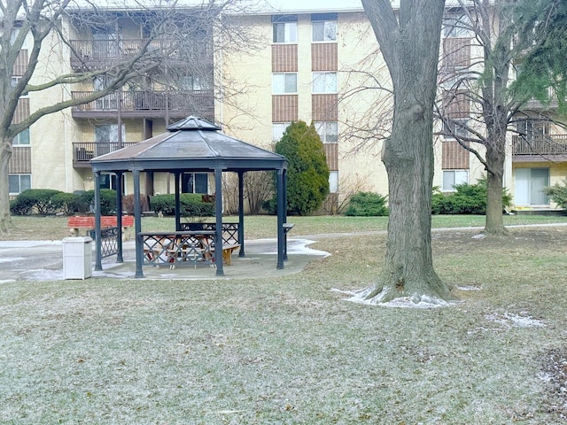 view of property's community with a yard and a gazebo