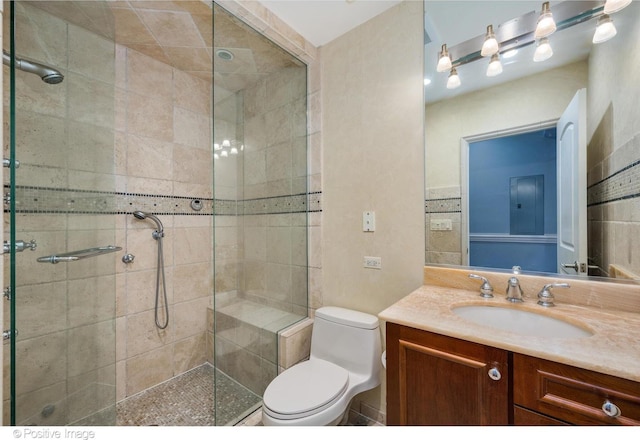 bathroom with vanity, toilet, and a shower stall