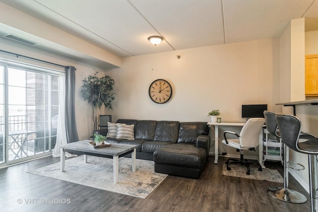 living area featuring visible vents and dark wood-style flooring