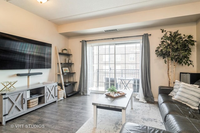 living area with dark wood-type flooring and visible vents