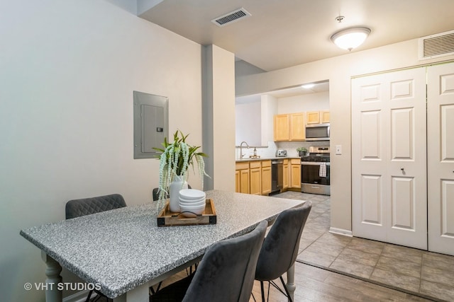 dining space featuring visible vents and electric panel