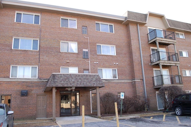 view of building exterior with uncovered parking