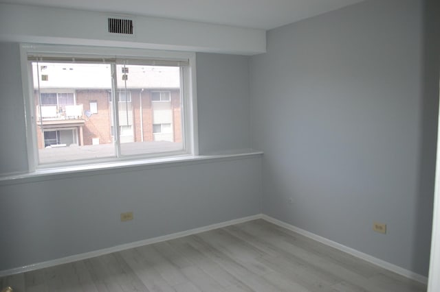 spare room featuring light wood-type flooring