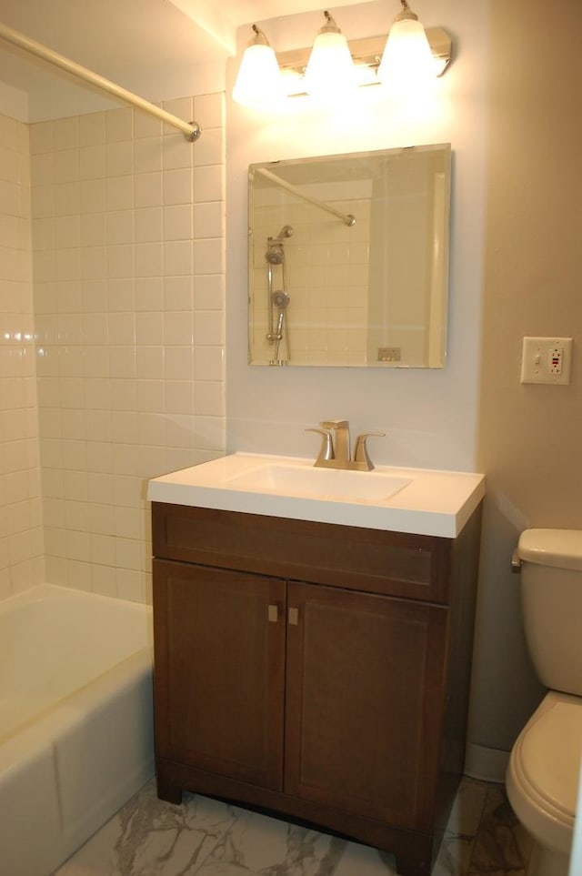 full bathroom featuring vanity, toilet, and tiled shower / bath