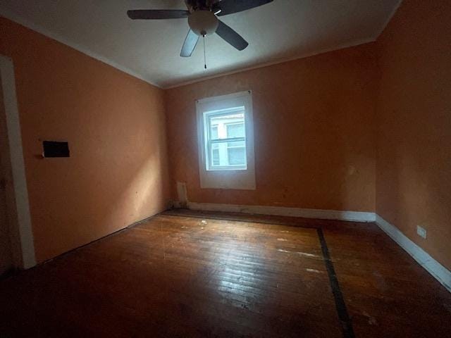 spare room with ceiling fan, crown molding, and wood-type flooring