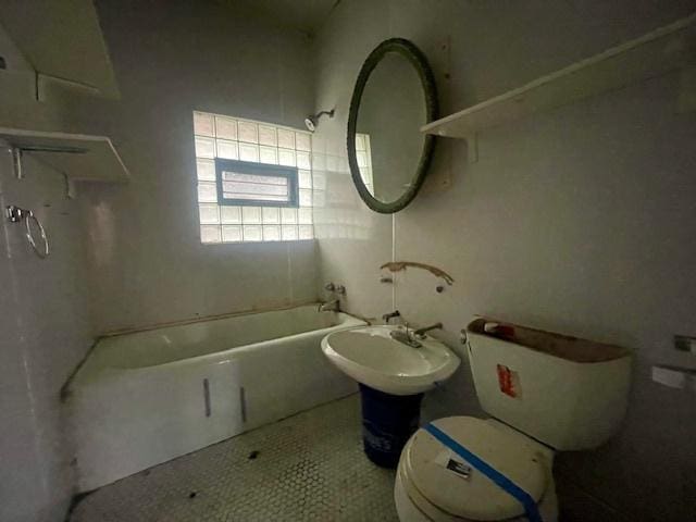 bathroom featuring tile patterned flooring, toilet, and  shower combination