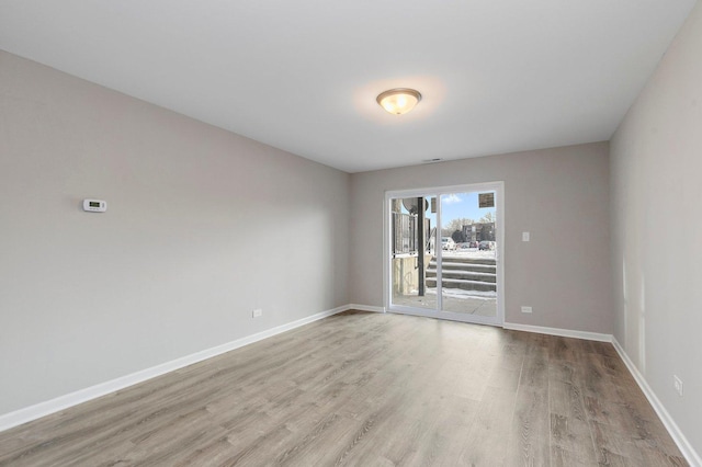 spare room featuring light hardwood / wood-style floors