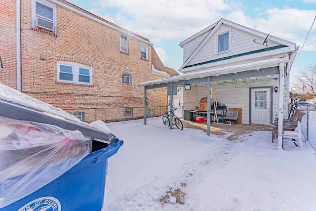 view of snow covered rear of property