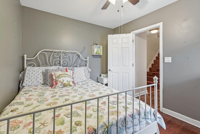 bedroom with ceiling fan, baseboards, and dark wood finished floors