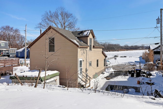 snow covered property with a garage