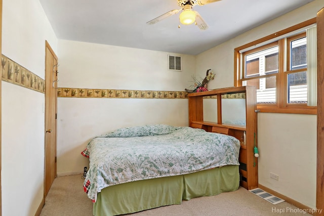 carpeted bedroom with baseboards, visible vents, and a ceiling fan