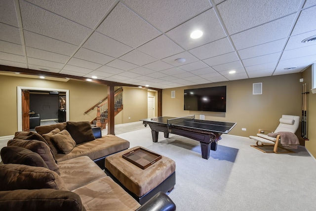 rec room with a paneled ceiling and carpet floors