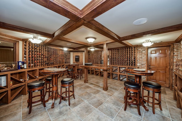 wine room with coffered ceiling and beamed ceiling