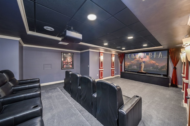 carpeted home theater featuring a tray ceiling and ornamental molding