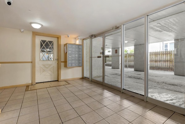 doorway to outside with light tile patterned floors, mail boxes, and a wall of windows