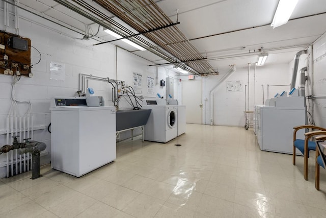 laundry area with washing machine and dryer and sink